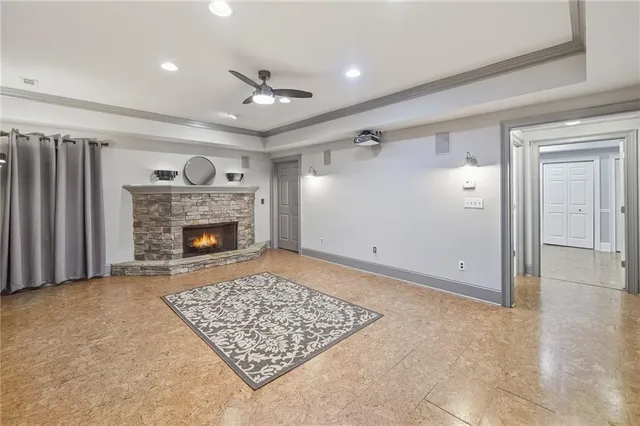 an empty room with windows and fireplace