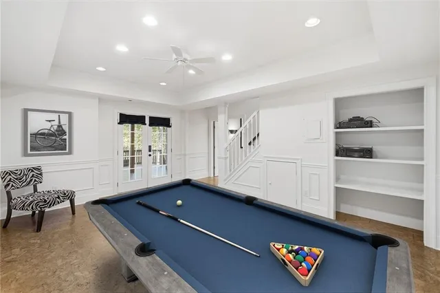 a living room with furniture pool table and window