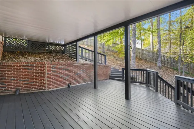 a view of house with a deck and furniture