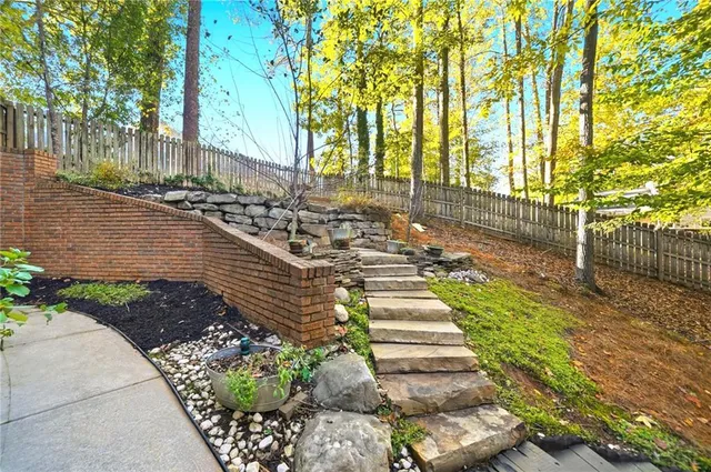 a view of a house with brick walls and plants