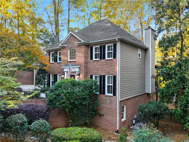 an aerial view of a house with a yard and garden