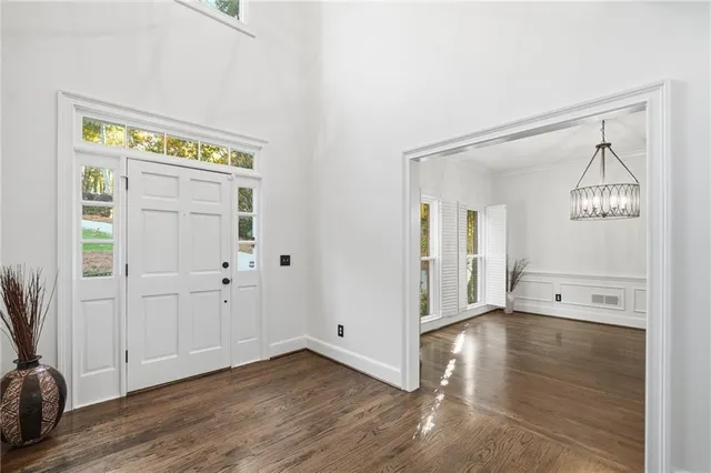 a view of an entryway with wooden floor