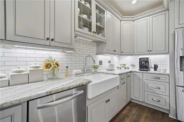a kitchen with stainless steel appliances granite countertop a sink a stove and cabinets
