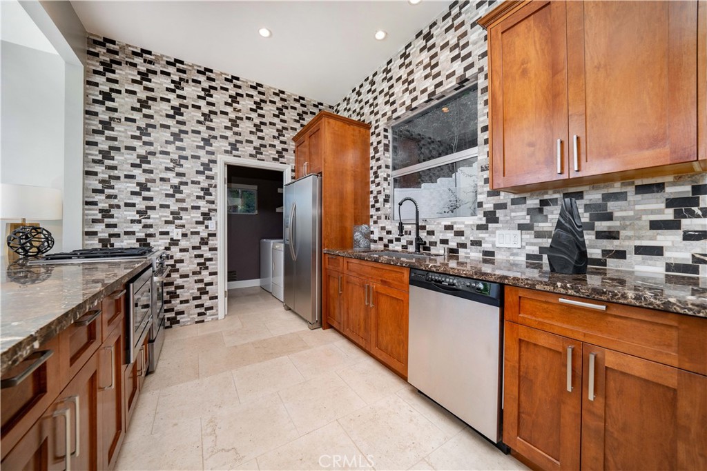 4104 Vanetta Place Studio City, CA 91604 - Photo 12 of 45 a kitchen with granite countertop a sink and a stove