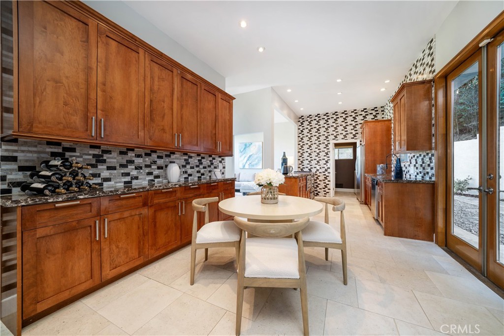 4104 Vanetta Place Studio City, CA 91604 - Photo 15 of 45 a kitchen with stainless steel appliances a sink a table and chairs