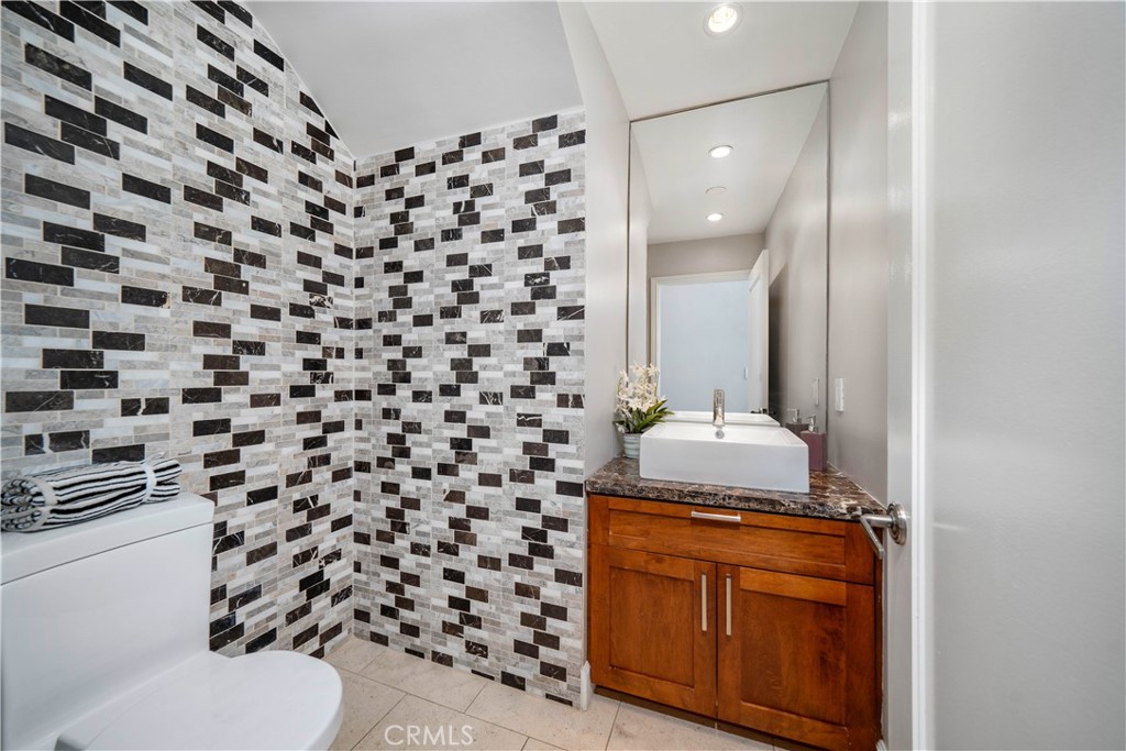 4104 Vanetta Place Studio City, CA 91604 - Photo 17 of 45 a bathroom with a granite countertop sink and a toilet