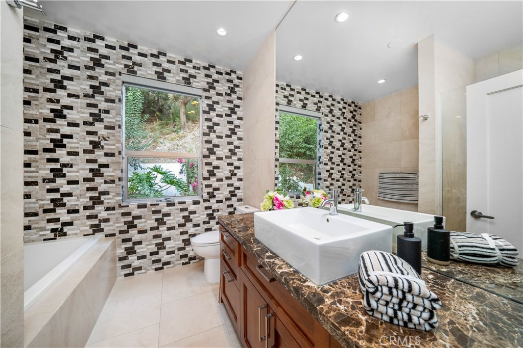 4104 Vanetta Place Studio City, CA 91604 - Photo 35 of 45 a bathroom with a bathtub sink and mirror