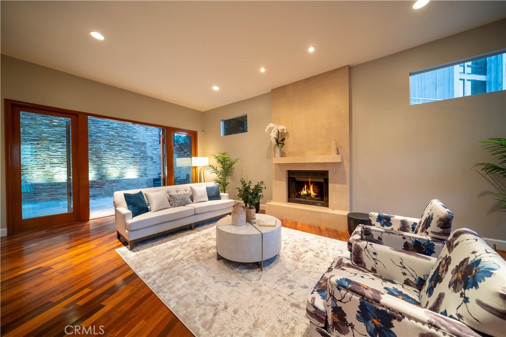 4104 Vanetta Place Studio City, CA 91604 - Photo 4 of 45 a living room with furniture a fireplace and a floor to ceiling window