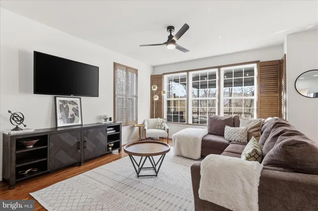 a living room with furniture and kitchen view