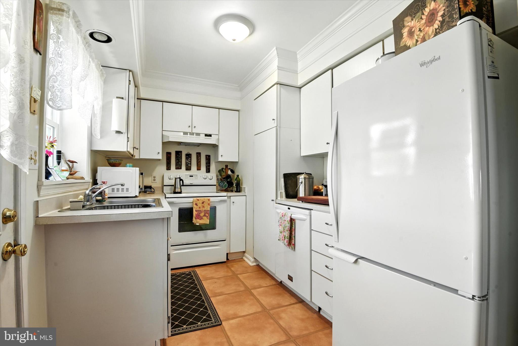 307 East Locust Street Union Bridge, MD 21791 - Photo 2 of 35 a kitchen with white cabinets and white appliances