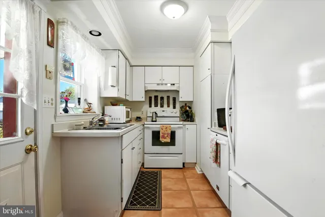 a kitchen with cabinets and appliances