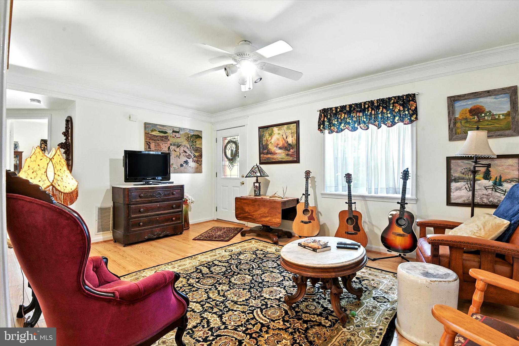 307 East Locust Street Union Bridge, MD 21791 - Photo 6 of 35 a living room with furniture a flat screen tv and a dining table