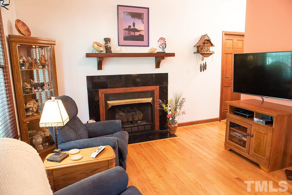 169 Willifords Point Road Roxboro, NC 27574 - Photo 12 of 30 a living room with furniture a flat screen tv and a fireplace