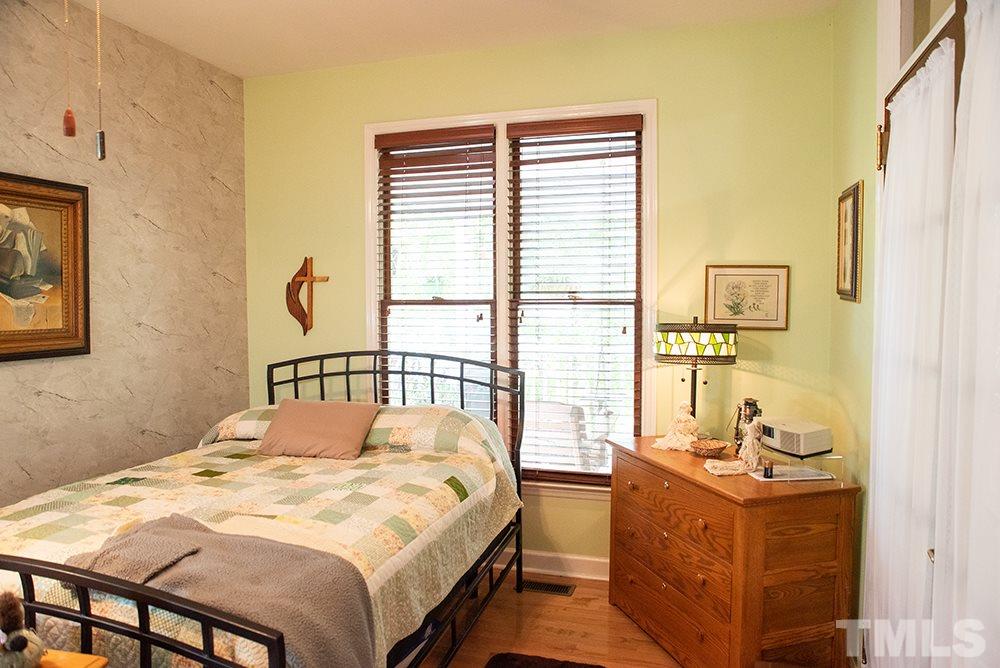 169 Willifords Point Road Roxboro, NC 27574 - Photo 13 of 30 a bedroom with a bed and a window