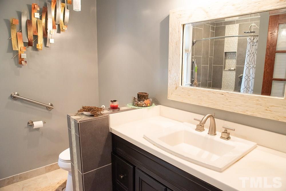 169 Willifords Point Road Roxboro, NC 27574 - Photo 14 of 30 a bathroom with a sink and a mirror