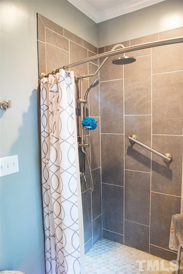 169 Willifords Point Road Roxboro, NC 27574 - Photo 15 of 30 a bathroom with a shower and a glass door shower