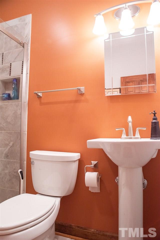 169 Willifords Point Road Roxboro, NC 27574 - Photo 19 of 30 a bathroom with a sink and a toilet