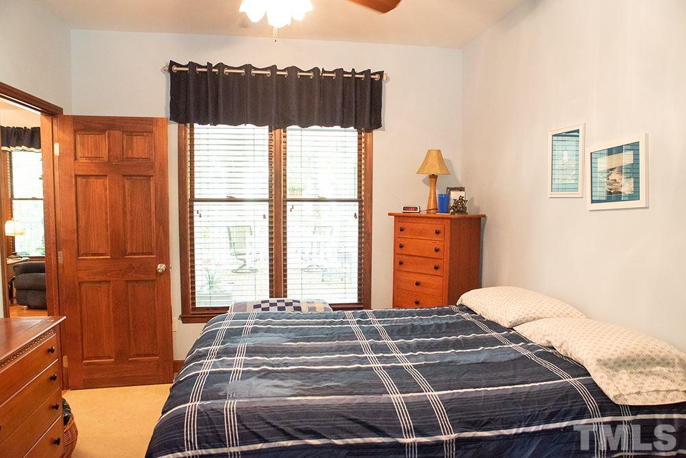 169 Willifords Point Road Roxboro, NC 27574 - Photo 20 of 30 a bedroom with a large bed and a window
