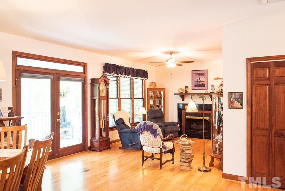 169 Willifords Point Road Roxboro, NC 27574 - Photo 10 of 30 a living room with furniture and a floor to ceiling window