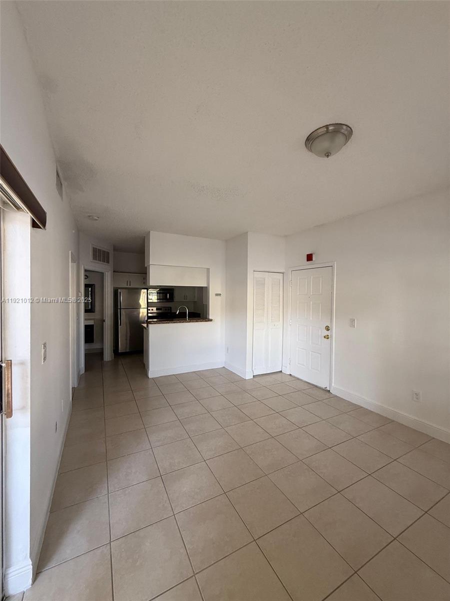18348 Northwest 68th Avenue, Unit E Hialeah, FL 33015 - Photo 4 of 8 a view of a kitchen with a sink and dishwasher cabinets