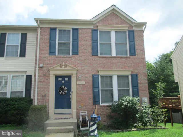 a front view of a house with garden and porch