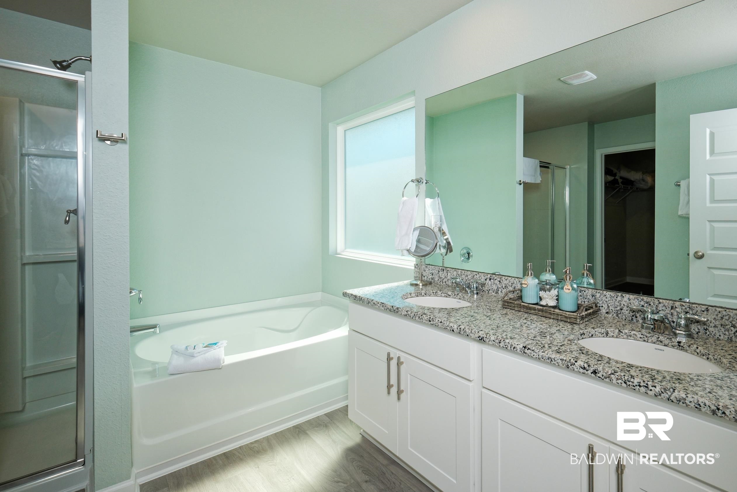 7425 Coppin Drive Foley, AL 36535 - Photo 19 of 41 Bathroom featuring vanity, independent shower and bath, and wood-type flooring