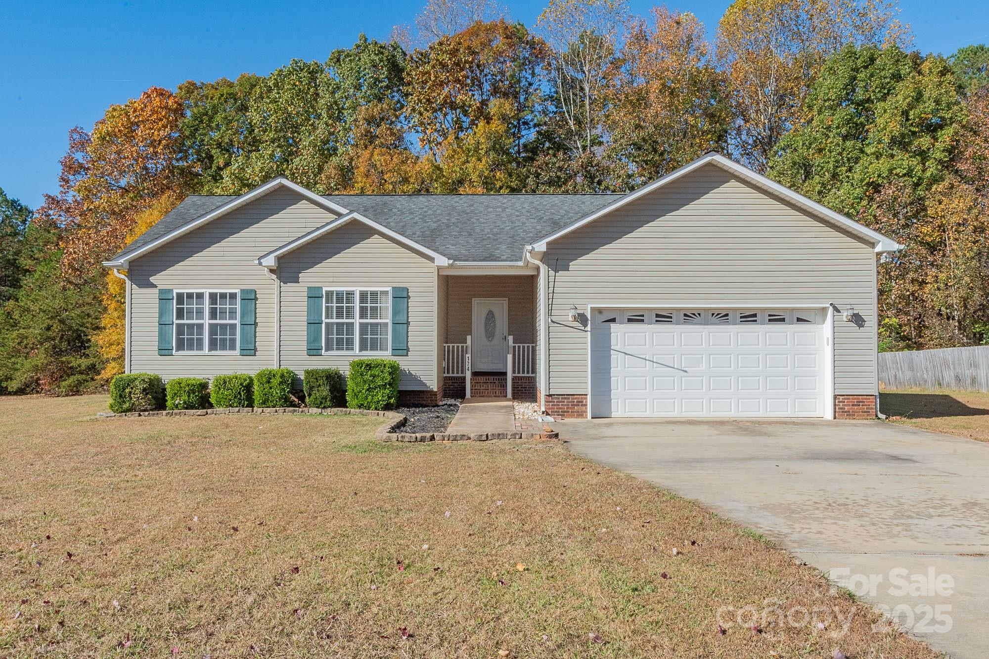 174 Isaiah Court Lexington, NC 27292 - Photo 1 of 37 a front view of a house with a yard and garage