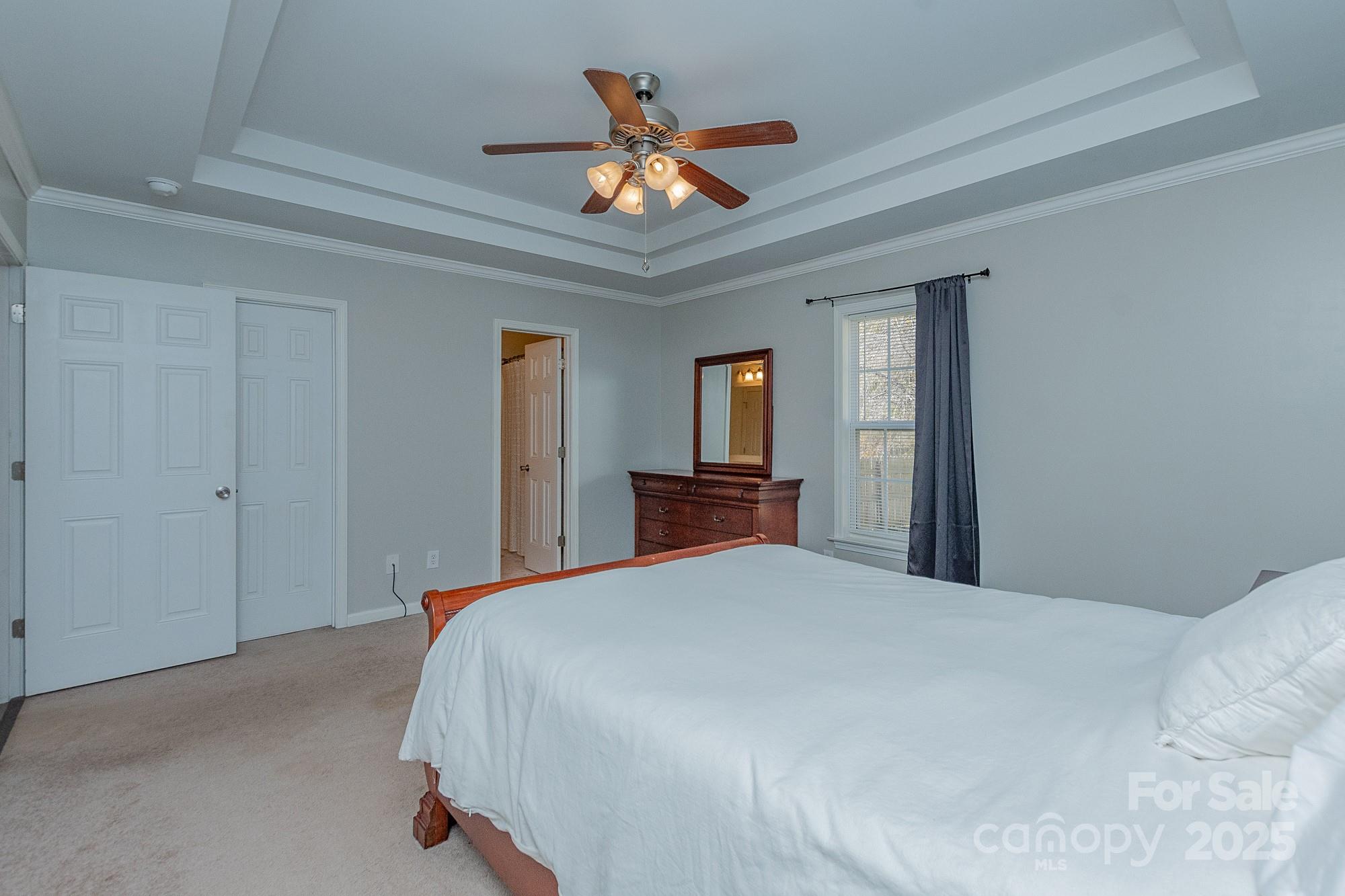 174 Isaiah Court Lexington, NC 27292 - Photo 13 of 37 a bedroom with a large bed and a ceiling fan