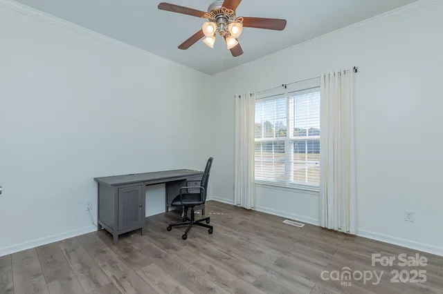 a workspace with wooden floor and a window