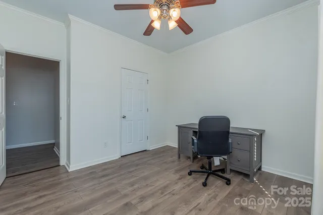 a view of workspace with wooden floor and windows