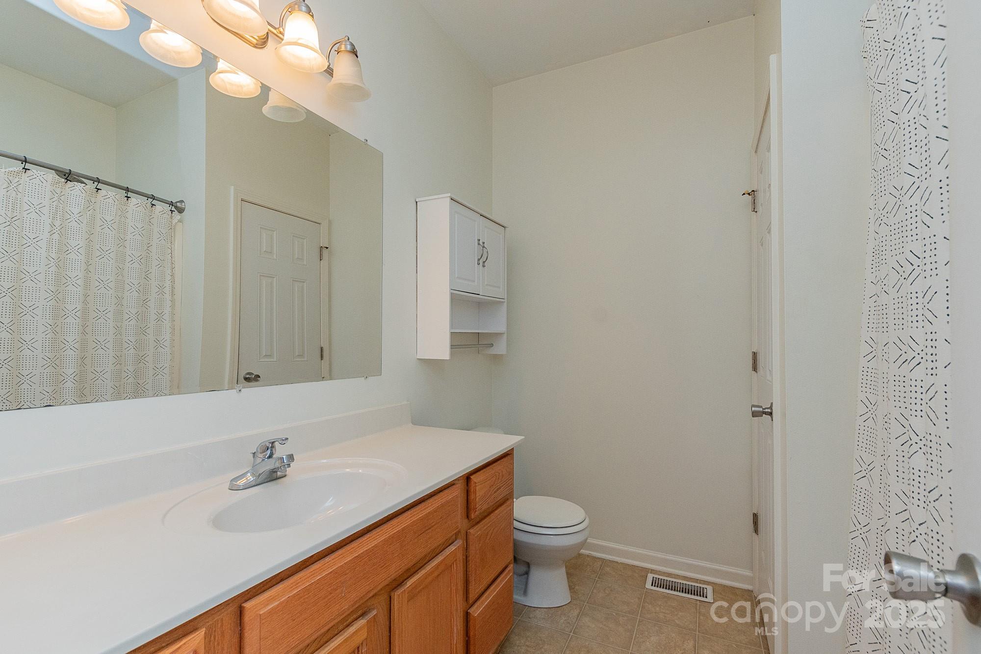 174 Isaiah Court Lexington, NC 27292 - Photo 18 of 37 a bathroom with a sink a toilet and shower