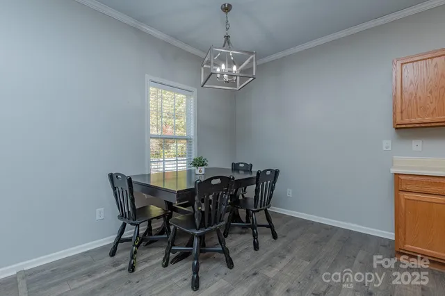 a view of a dining room with furniture and window
