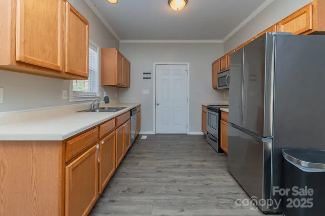 a kitchen with stainless steel appliances granite countertop a sink stove and cabinets