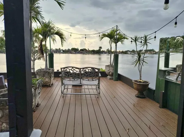 a view of a balcony with chairs and wooden floor
