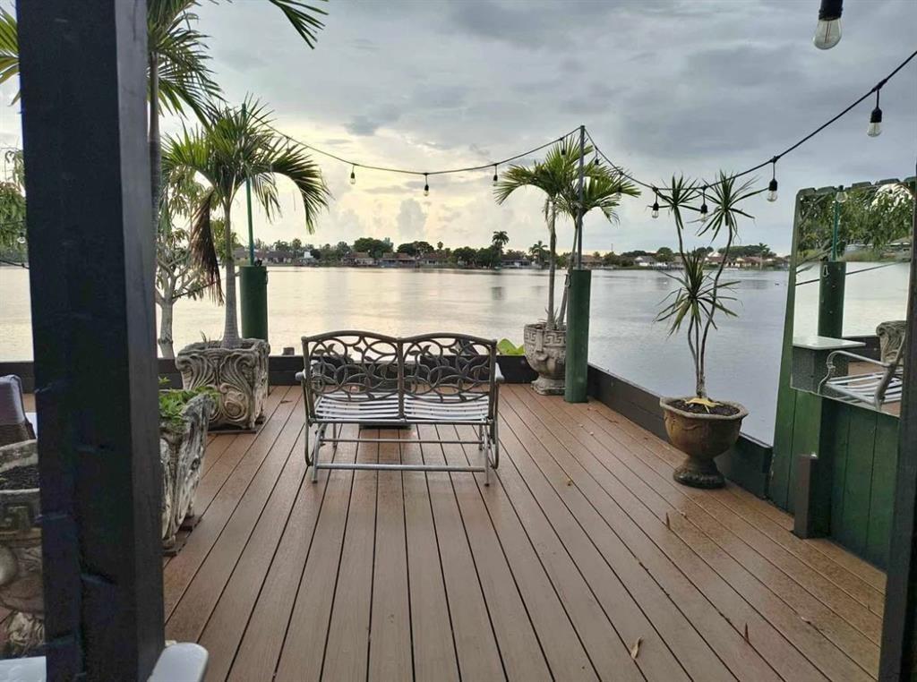 5741 Southwest 24th Avenue, Unit A Fort Lauderdale, FL 33312 - Photo 1 of 14 a view of a balcony with chairs and wooden floor