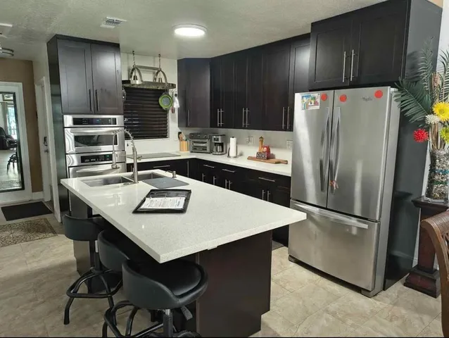 a kitchen with stainless steel appliances a refrigerator and a stove