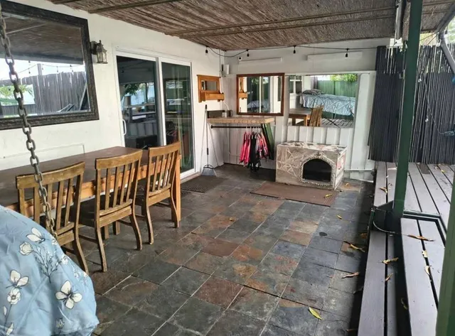 a view of a patio with a table and chairs