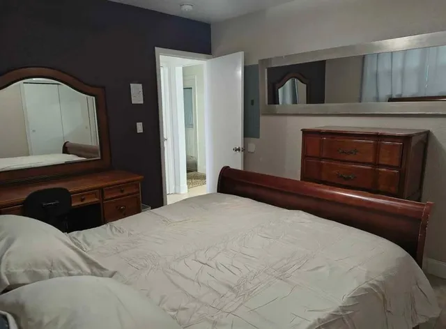 a bedroom with a bed and a fireplace