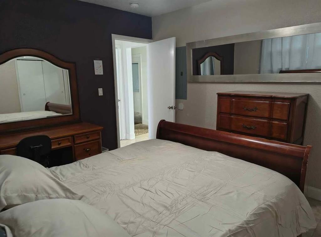 5741 Southwest 24th Avenue, Unit A Fort Lauderdale, FL 33312 - Photo 7 of 14 a bedroom with a bed and a fireplace