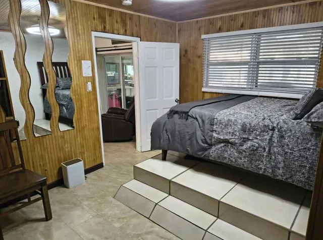 a bedroom with a bed and a window