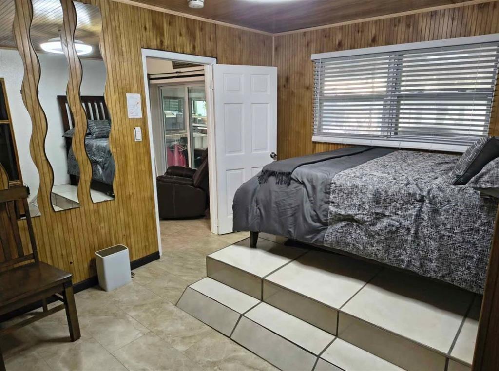 5741 Southwest 24th Avenue, Unit A Fort Lauderdale, FL 33312 - Photo 9 of 14 a bedroom with a bed and a window