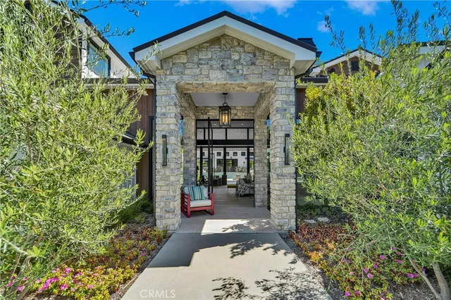 a view of a porch with a table and chairs and potted plants