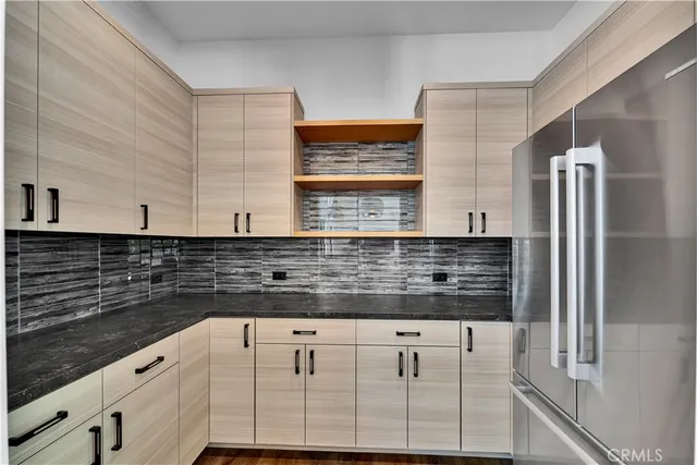 a kitchen with granite countertop white cabinets and stainless steel appliances