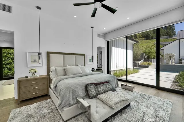 a bedroom with a large bed and a large window