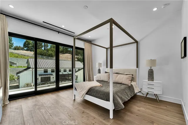 a spacious bedroom with a bed and a night stand