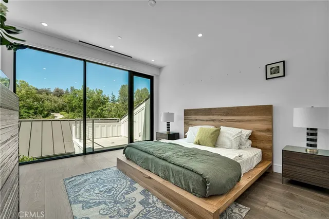 a bedroom with a large bed and a large window