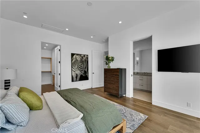 a bedroom with a bed and a flat screen tv