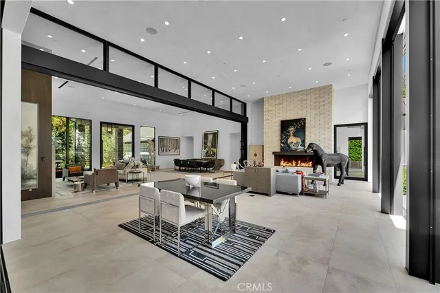 a living room with furniture a rug and a large window