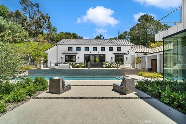 a front view of a house with a garden and plants