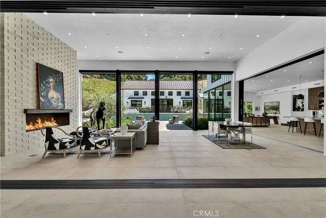 a living room with furniture and large windows